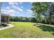 Spacious backyard with lush grass and a glimpse of the house and screened porch at 45 Leighann S Ct, Timberlake, NC 27583
