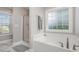 Bright bathroom with a large soaking tub, shower, and window with frosted glass at 45 Leighann S Ct, Timberlake, NC 27583