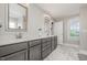 Elegant bathroom featuring double vanity with modern sinks and large framed mirrors at 45 Leighann S Ct, Timberlake, NC 27583