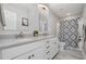 Bright bathroom with double sinks, gray countertop and modern cabinets plus shower at 45 Leighann S Ct, Timberlake, NC 27583