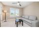 Neutral bedroom with carpet, a ceiling fan, a large window, and a comfortable gray couch at 45 Leighann S Ct, Timberlake, NC 27583