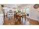 Bright dining area adjacent to the kitchen with white cabinets and stainless steel appliances at 45 Leighann S Ct, Timberlake, NC 27583