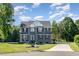Beautiful two-story home featuring gray siding, black shutters, a well-manicured lawn and a concrete driveway at 45 Leighann S Ct, Timberlake, NC 27583