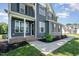 Inviting front porch with dark gray siding, white trim, and manicured landscaping at 45 Leighann S Ct, Timberlake, NC 27583
