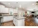 Open-concept kitchen with granite countertops, white cabinetry, a center island, and stainless appliances at 45 Leighann S Ct, Timberlake, NC 27583