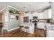 Well-lit kitchen featuring a center island, stainless steel appliances, and sleek white cabinetry at 45 Leighann S Ct, Timberlake, NC 27583
