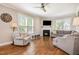 Bright living room with hardwood floors, large windows, a fireplace and comfortable seating at 45 Leighann S Ct, Timberlake, NC 27583