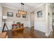 Well-lit living room featuring hardwood floors, white wainscoting, and tasteful decor at 45 Leighann S Ct, Timberlake, NC 27583