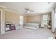 Large main bedroom with a ceiling fan, neutral walls, and comfortable seating area at 45 Leighann S Ct, Timberlake, NC 27583