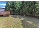 Spacious backyard with mature trees, offering a serene outdoor space perfect for relaxation and entertaining at 4533 Whistling Way, Raleigh, NC 27616