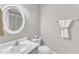 Neutral-toned bathroom with a round mirror, pedestal sink, and coordinated towel set at 4533 Whistling Way, Raleigh, NC 27616
