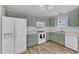 Well-lit kitchen with green cabinets, modern appliances, and ample counter space at 4533 Whistling Way, Raleigh, NC 27616