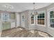 Eat-in kitchen with green cabinets, a dining area, and bright windows overlooking a private deck at 4533 Whistling Way, Raleigh, NC 27616