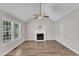 Bright living room featuring a fireplace, vaulted ceiling, and natural light from large windows at 4533 Whistling Way, Raleigh, NC 27616
