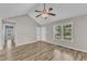 Spacious living room with vaulted ceiling, wood-look floors, and lots of natural light at 4533 Whistling Way, Raleigh, NC 27616