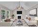 Inviting living room featuring vaulted ceilings, a cozy fireplace, and lots of natural light at 4533 Whistling Way, Raleigh, NC 27616