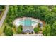 Aerial view of the community pool area with lounge chairs and shade umbrellas at 4562 Brighton Ridge Dr, Apex, NC 27539
