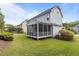 Exterior view of home with a screened-in porch and backyard with a grassy lawn at 4562 Brighton Ridge Dr, Apex, NC 27539