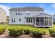 View of the home's rear exterior featuring a screened-in porch and well-maintained lawn at 4562 Brighton Ridge Dr, Apex, NC 27539