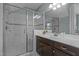 Bathroom with a glass shower and vanity with dark wood cabinets at 4562 Brighton Ridge Dr, Apex, NC 27539