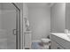 Modern bathroom with a glass shower, white vanity, and neutral tile flooring at 4562 Brighton Ridge Dr, Apex, NC 27539
