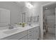 Bright bathroom featuring double sinks, white cabinetry, and tile flooring at 4562 Brighton Ridge Dr, Apex, NC 27539