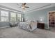 Spacious bedroom with tray ceiling, soft colors, and carpet floors at 4562 Brighton Ridge Dr, Apex, NC 27539