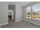 Bedroom with large window, grey carpet and neutral paint at 4562 Brighton Ridge Dr, Apex, NC 27539