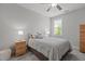 Bedroom featuring neutral paint, window, ceiling fan, and cozy bedding at 4562 Brighton Ridge Dr, Apex, NC 27539
