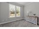 Bedroom features a large window, grey carpet, and a decorative dresser at 4562 Brighton Ridge Dr, Apex, NC 27539