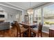 The dining area with a wood table, seating for four, and natural light from large windows at 4562 Brighton Ridge Dr, Apex, NC 27539
