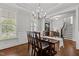 Dining room with hardwood floors, chandelier, natural light, and view of the front entry and staircase at 4562 Brighton Ridge Dr, Apex, NC 27539