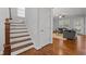 Welcoming entryway featuring hardwood floors, staircase, and a glimpse into the adjacent living room at 4562 Brighton Ridge Dr, Apex, NC 27539