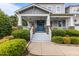 Inviting front porch with stone accents, white railings, and a charming blue double-door entrance at 4562 Brighton Ridge Dr, Apex, NC 27539