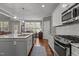 Gourmet kitchen with island, stainless appliances, hardwood floors, and an adjacent dining area at 4562 Brighton Ridge Dr, Apex, NC 27539