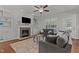 Comfortable living room with a fireplace, built-in shelving, and two large sofas at 4562 Brighton Ridge Dr, Apex, NC 27539