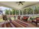 A cozy screened porch with outdoor furniture, a ceiling fan, and views of the backyard at 4562 Brighton Ridge Dr, Apex, NC 27539