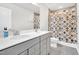 Bathroom featuring double sinks with marble countertop, a large mirror, and a shower at 4601 Okeechobee Ct, Fuquay Varina, NC 27526