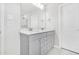 Bright bathroom featuring double sinks with marble countertop, and a large mirror at 4601 Okeechobee Ct, Fuquay Varina, NC 27526