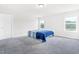 Bright bedroom features a light grey carpet, two large windows, and neutral paint at 4601 Okeechobee Ct, Fuquay Varina, NC 27526