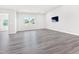 Open bonus room with modern wood flooring, recessed lighting, and large windows at 4601 Okeechobee Ct, Fuquay Varina, NC 27526