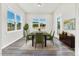 Dining room with a wooden table, chairs, and large windows, providing ample natural light at 4601 Okeechobee Ct, Fuquay Varina, NC 27526
