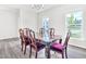 Formal dining room with wood table and chairs situated beneath a chandelier and a large window at 4601 Okeechobee Ct, Fuquay Varina, NC 27526