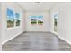 Bright dining area with large windows and wood floors, creating an inviting atmosphere at 4601 Okeechobee Ct, Fuquay Varina, NC 27526