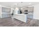 Spacious kitchen with an island, modern appliances, ample counter space, and gray cabinets at 4601 Okeechobee Ct, Fuquay Varina, NC 27526