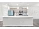 Modern kitchen with a center island, light gray cabinets, white countertops, and stainless steel appliances at 4601 Okeechobee Ct, Fuquay Varina, NC 27526