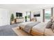 Spacious main bedroom featuring two windows, TV, dresser, and stylish decor for a comfortable retreat at 4601 Okeechobee Ct, Fuquay Varina, NC 27526