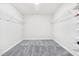 Empty walk-in closet with carpeted floor, wire racks, and neutral paint at 4601 Okeechobee Ct, Fuquay Varina, NC 27526