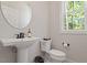 Chic half bath features a pedestal sink, modern fixtures, and natural light at 509 Sherron Rd # 11, Durham, NC 27703