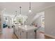 Bright, open kitchen with large island, modern lighting, and stainless steel appliances overlooks the living area at 509 Sherron Rd # 11, Durham, NC 27703